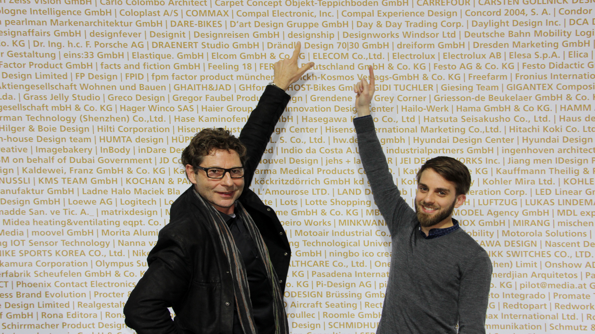 Thomas Starczewski (designer and founder) and Piero Horn from designship point to the lettering on the winner wall. The designship team of designers received two awards at the BMW Welt in Munich. BMW Welt München - Messe - iF Product Design Award 2015 - best of the best - design award - designship GmbH - Product Design - Industrial Design - Interface Design - iF world design index - Top 25 Industry - Top 100 design studios worldwide - we love design